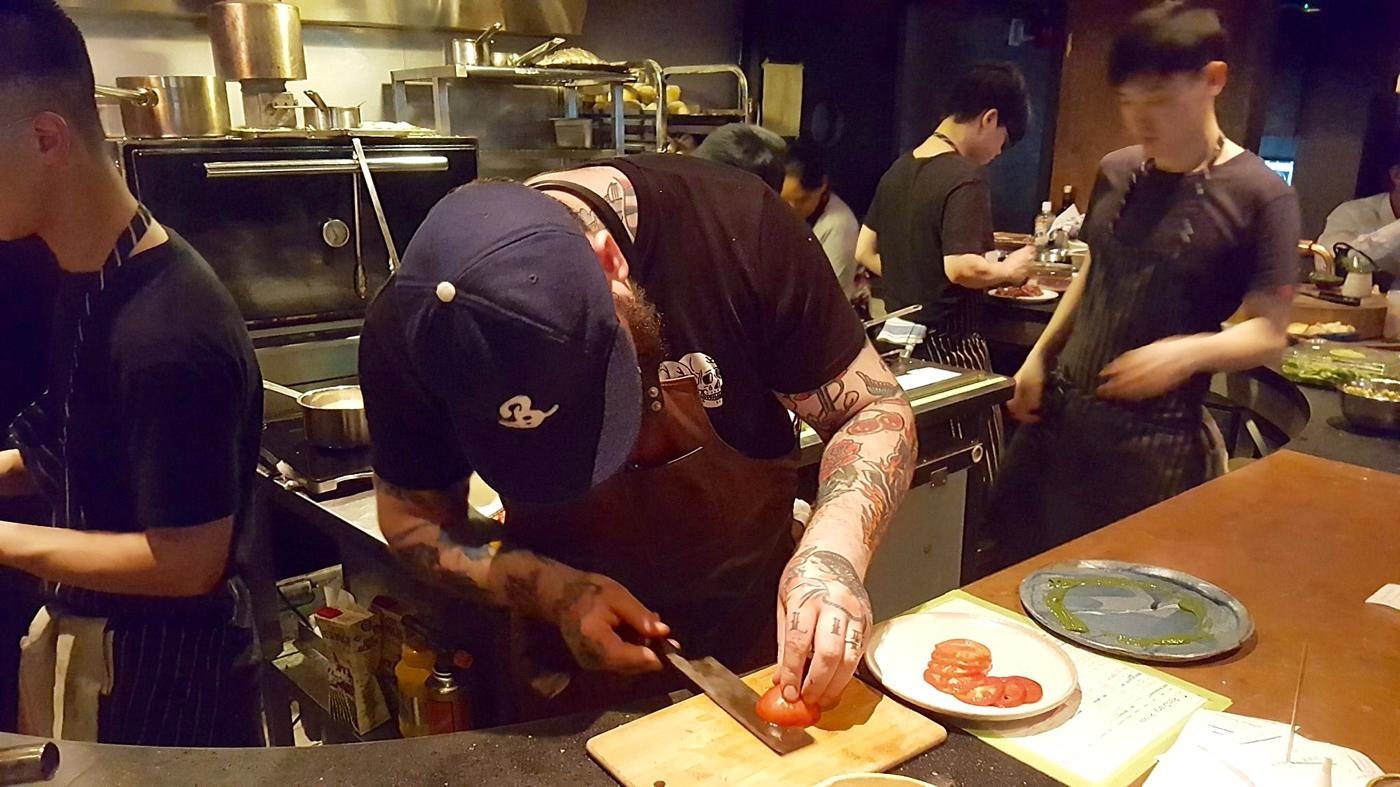 Rhoda Chef Nathan Green thinly slicing Komamoto Tomatoes